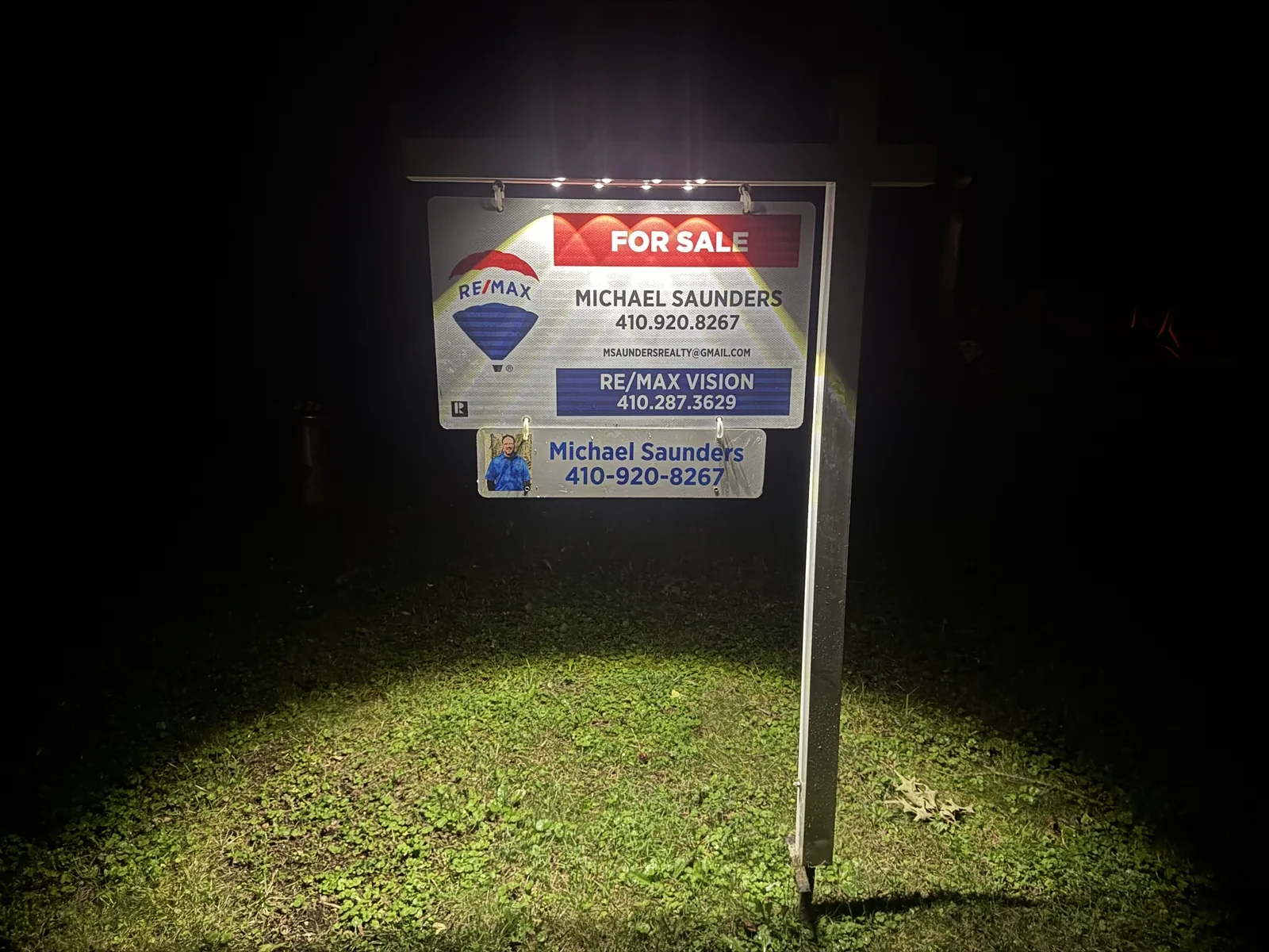 Tri-State Negotiator RE/MAX Vision for sale sign glowing at night under its solar light